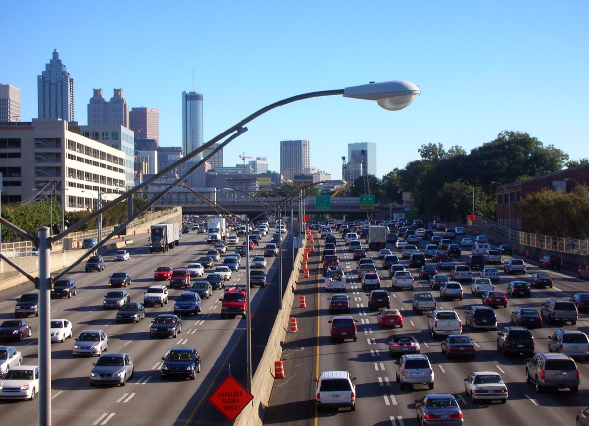 The downtown Atlanta skyline seen from a highway on a clear afternoon.